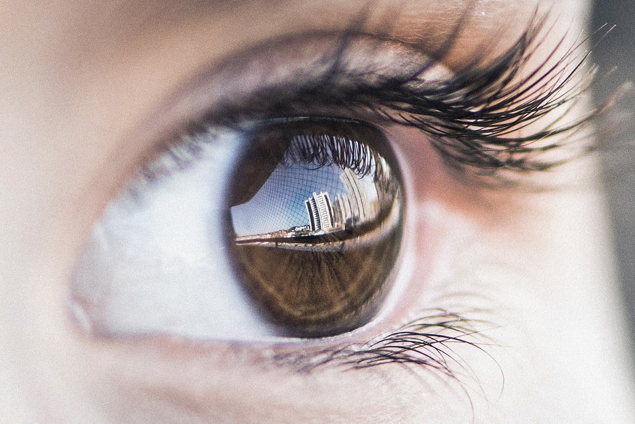 Close-up of a brown eye with long, dark lashes